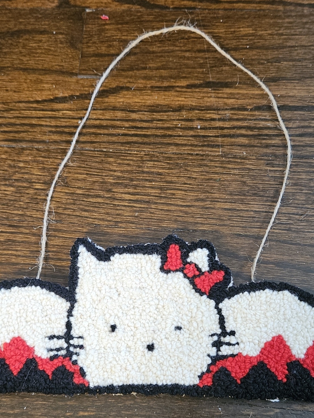 Handmade White Kitty Hooked Wall Hanging with Red Bow Accent